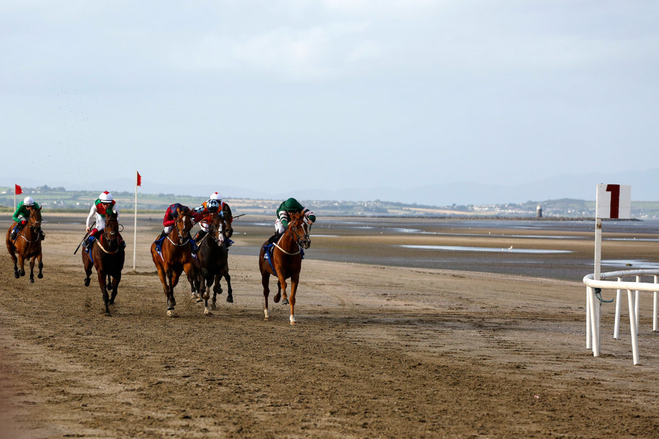 Runners battling it out on the sand at Laytown.