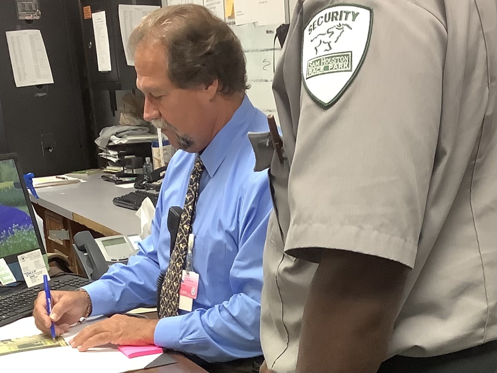 Don Ahrens (pictured left) designs a traffic pattern for one of his staff during the Sam Houston Race Park Quarter Horse Meet. As the Director of Security and Parking, he leads a team that is charged with keeping the public, the staff, and the animals, as safe as possible.